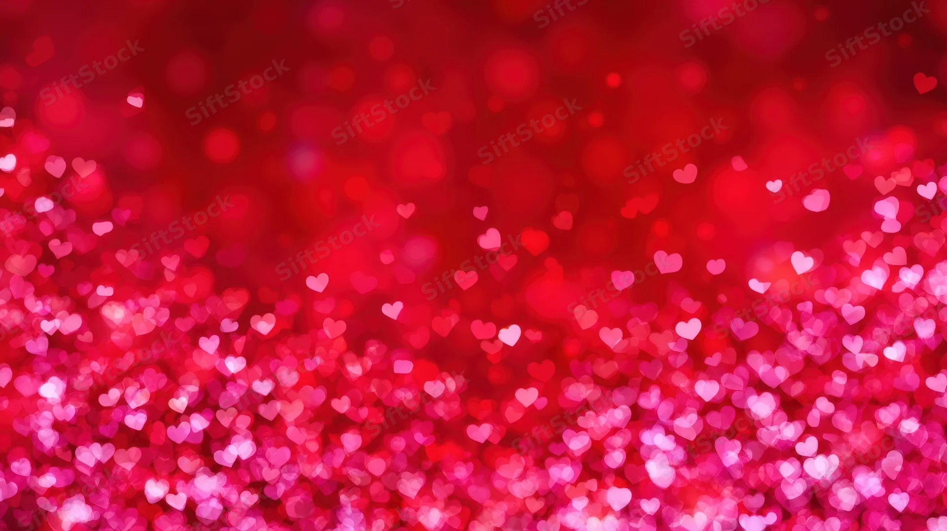 Red and pink heart-shaped bokeh lights forming a sparkling festive background
