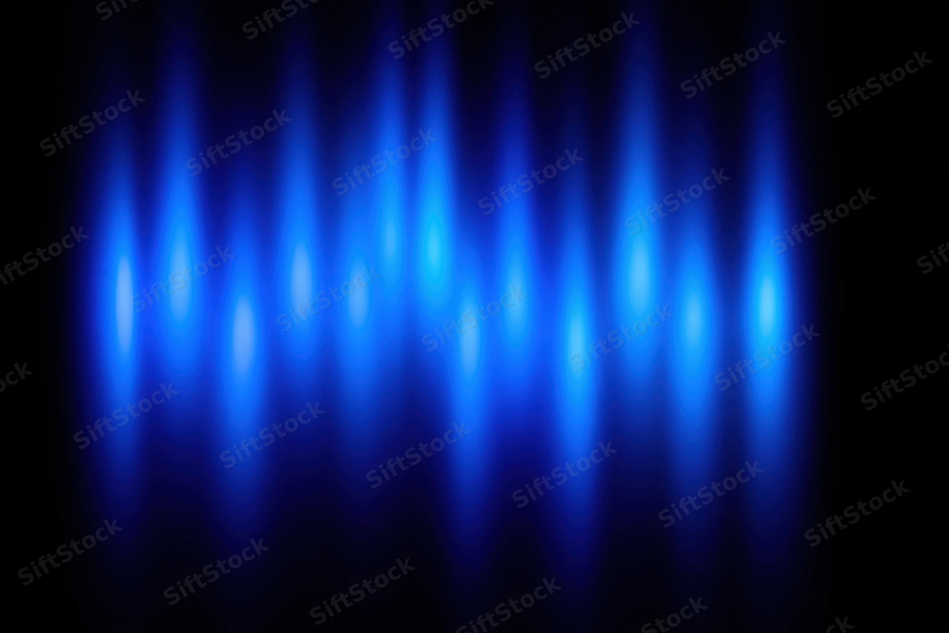 Blue spotlights glowing vertically on a dark background