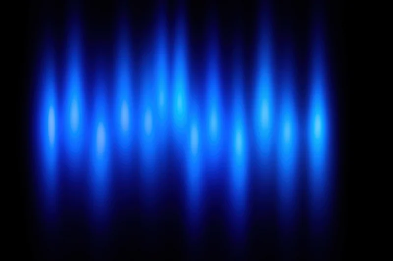 Blue spotlights glowing vertically on a dark background