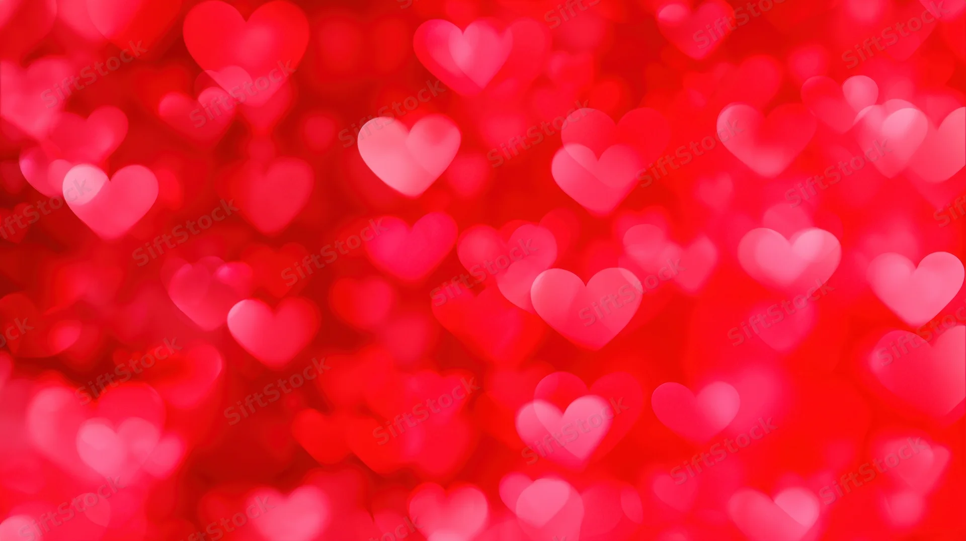 Blurred red hearts floating in soft focus as a romantic background