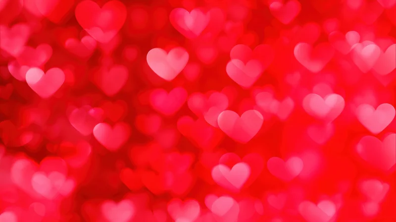 Blurred red hearts floating in soft focus as a romantic background