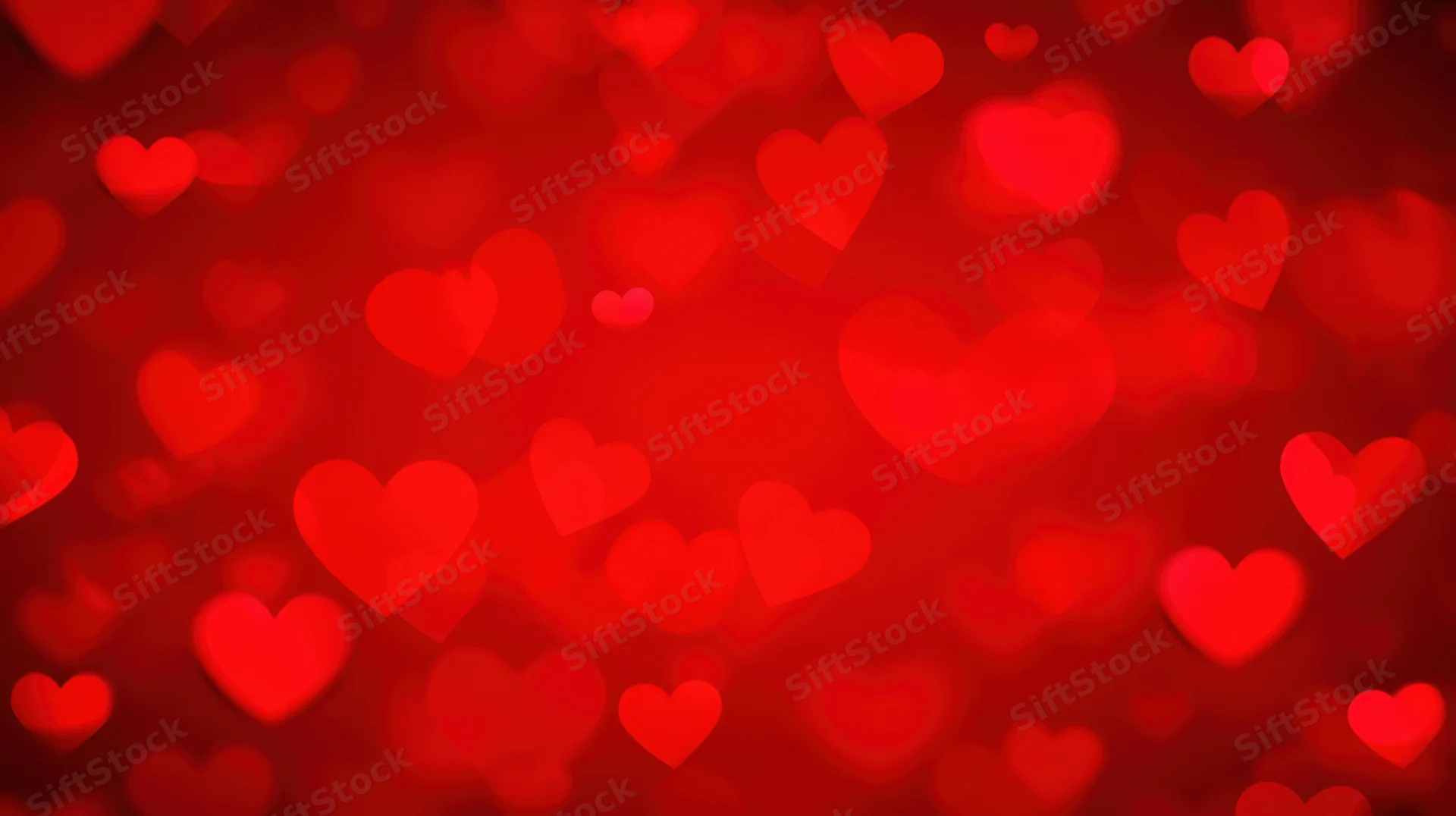 Blurred red hearts floating in soft focus as a romantic background