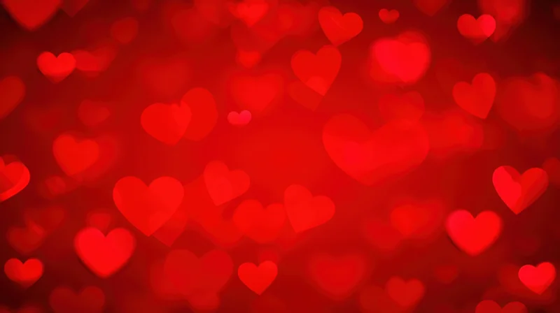Blurred red hearts floating in soft focus as a romantic background