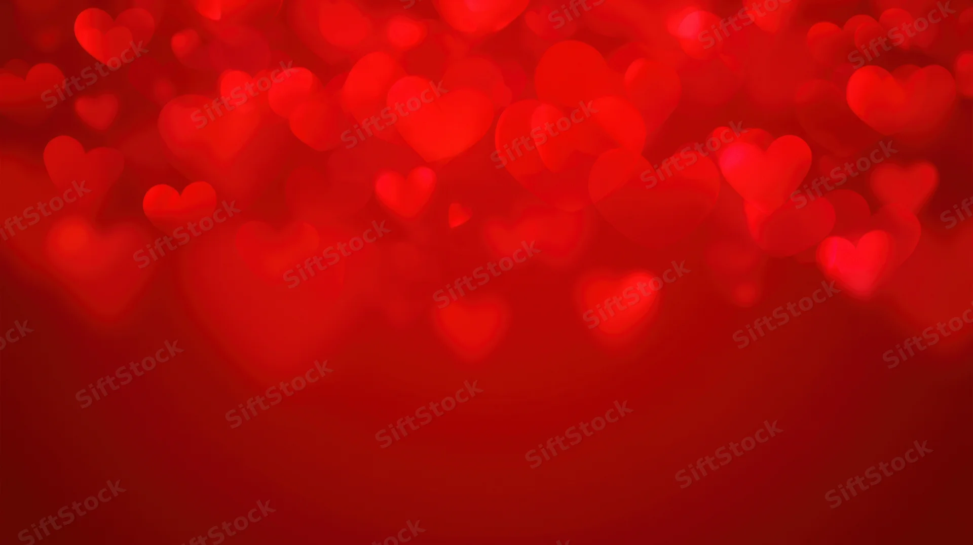 Red heart-shaped bokeh lights floating against a blurred background