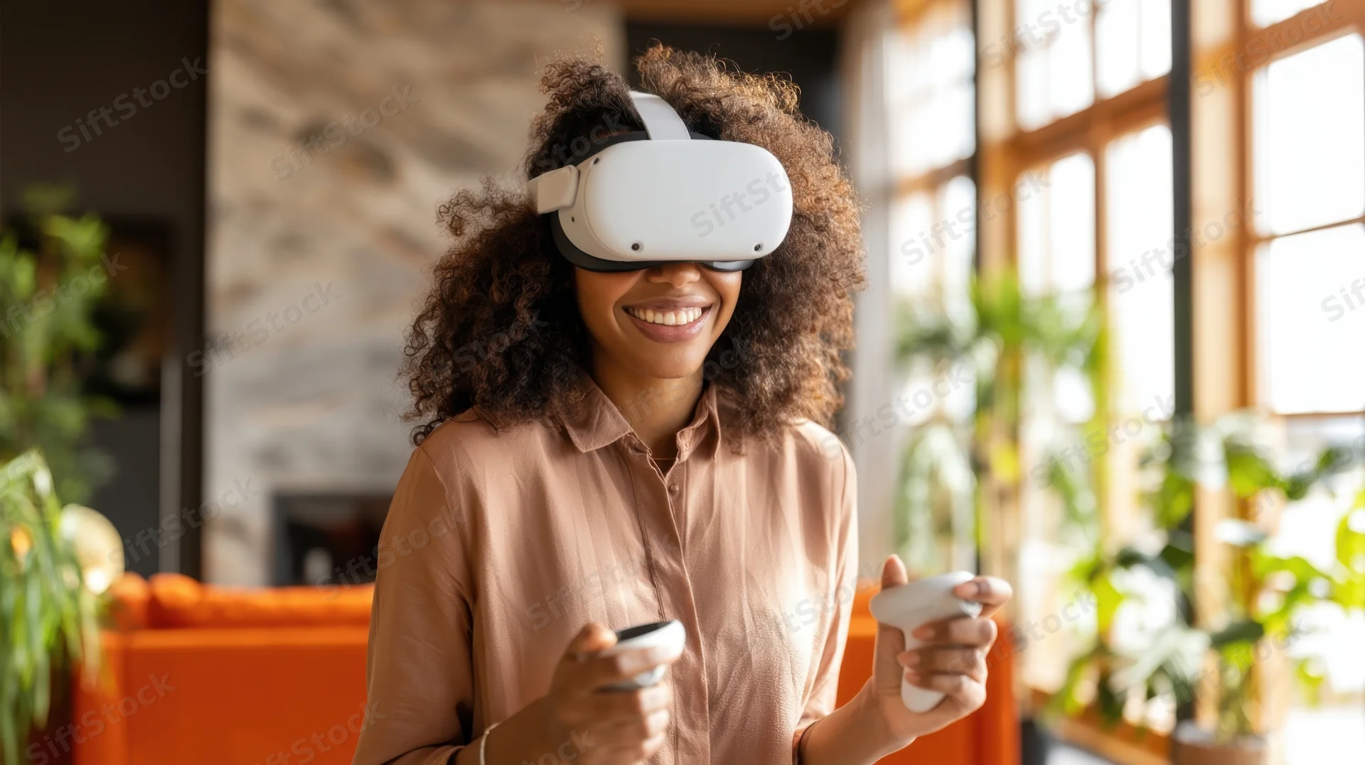 Young woman smiling while using vr headset and controllers in a bright living room with plants and orange sofa