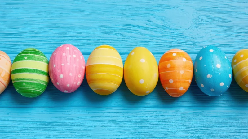 Decorated easter eggs in a row on a blue wooden surface