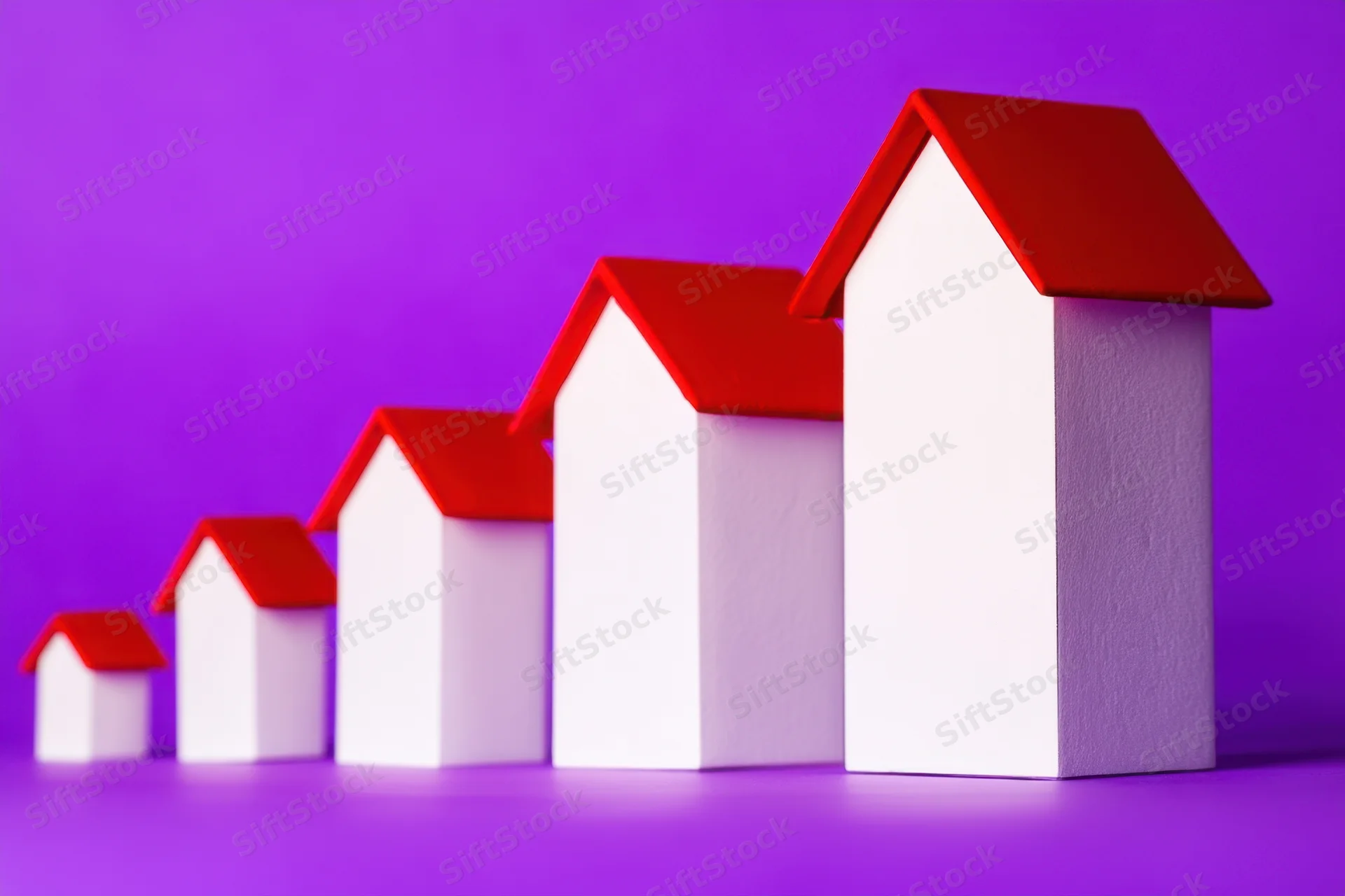 Row of white miniature houses with red roofs increasing in size from left to right on purple background