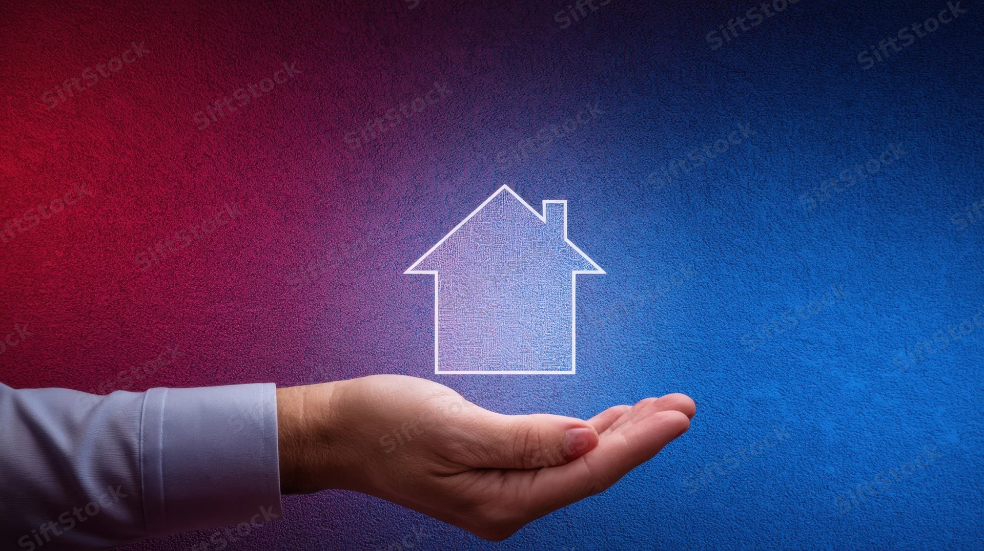 Hand holding a glowing house outline against a red to blue gradient background