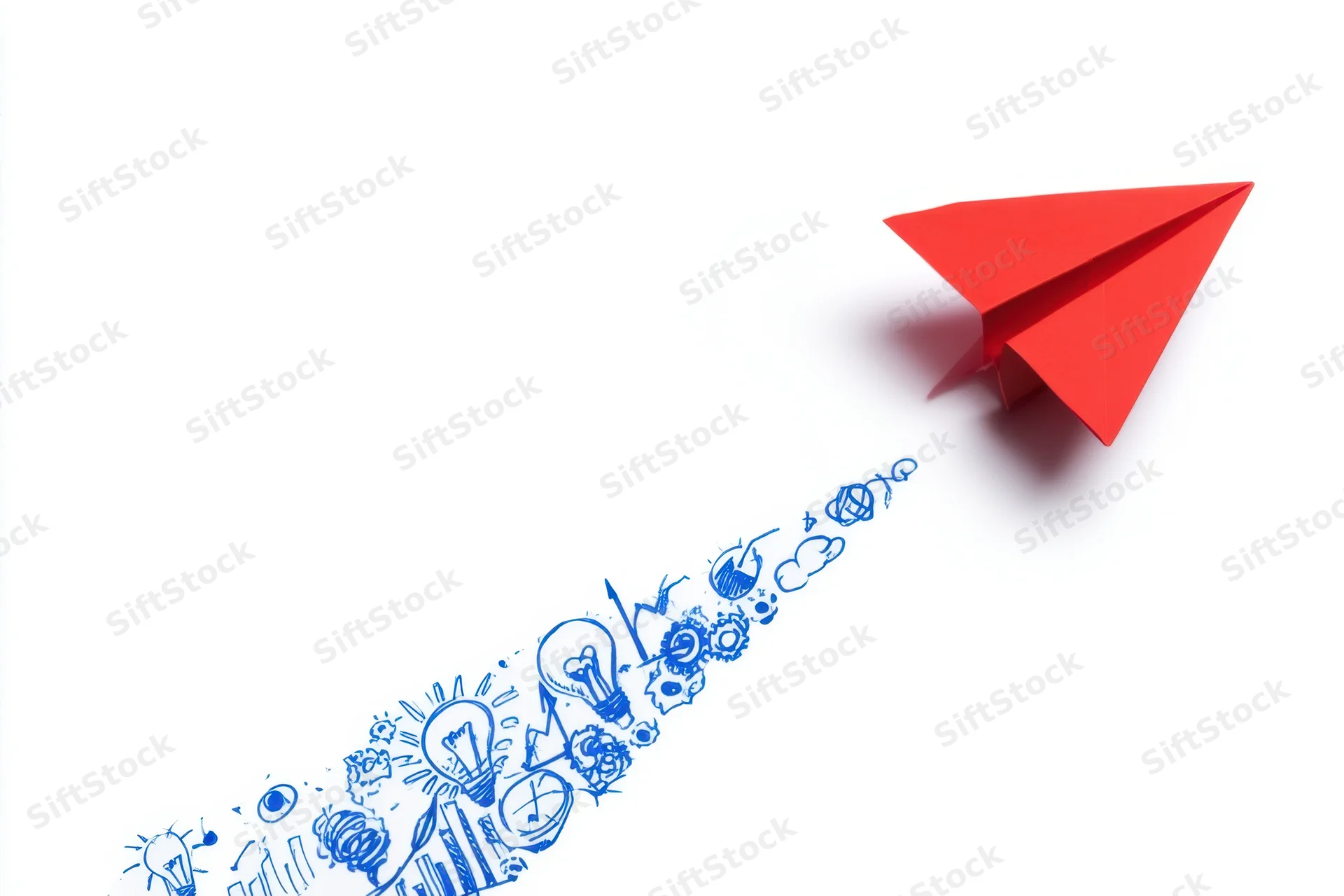 Red origami paper airplane flying forward leaving a trail of blue innovation icons on white background