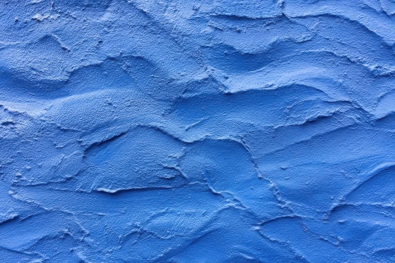 Close-up of blue textured plaster wall surface