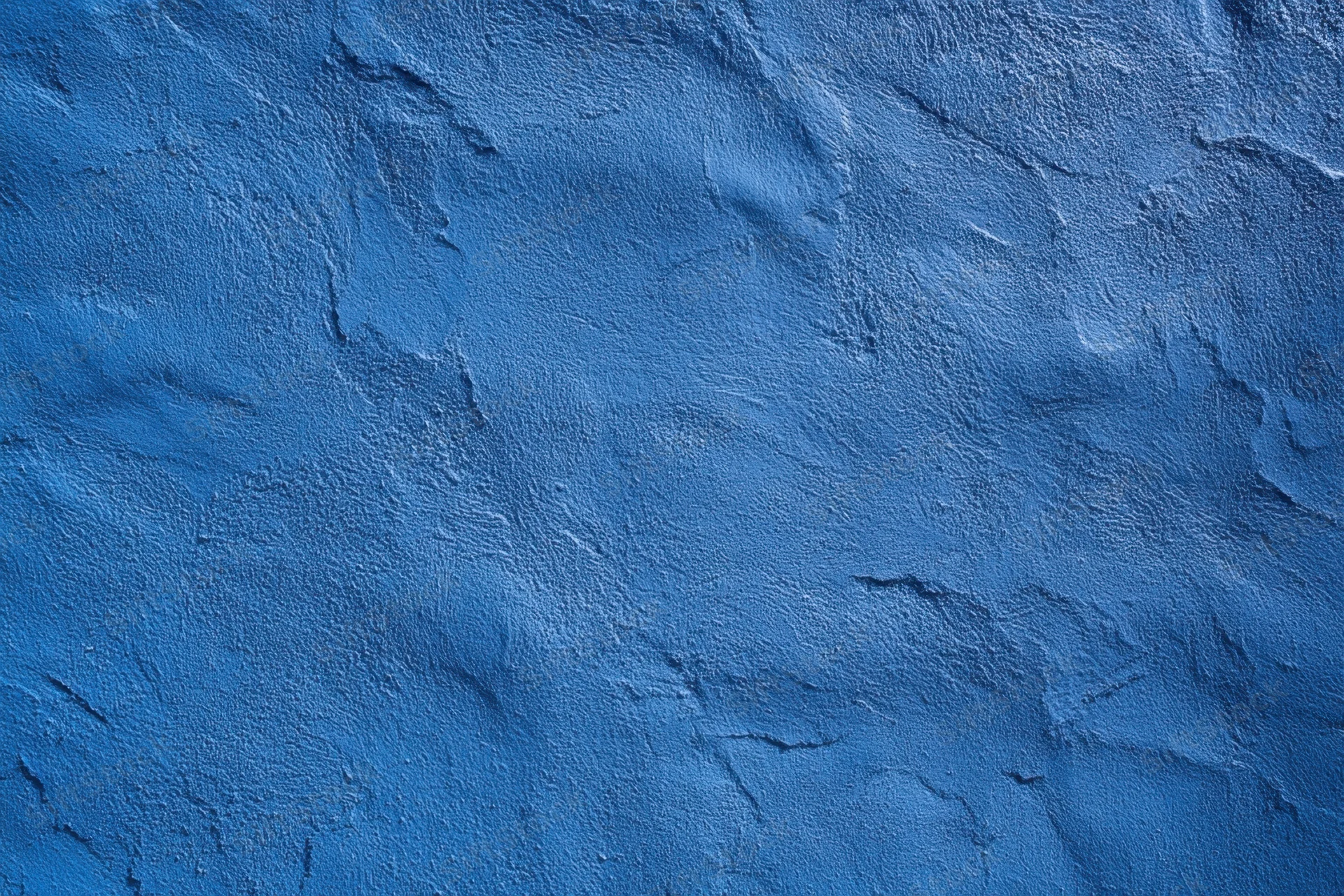 Close-up of a blue textured wall with rough plaster surface