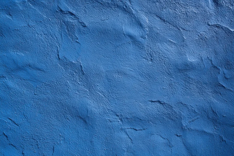 Close-up of a blue textured wall with rough plaster surface