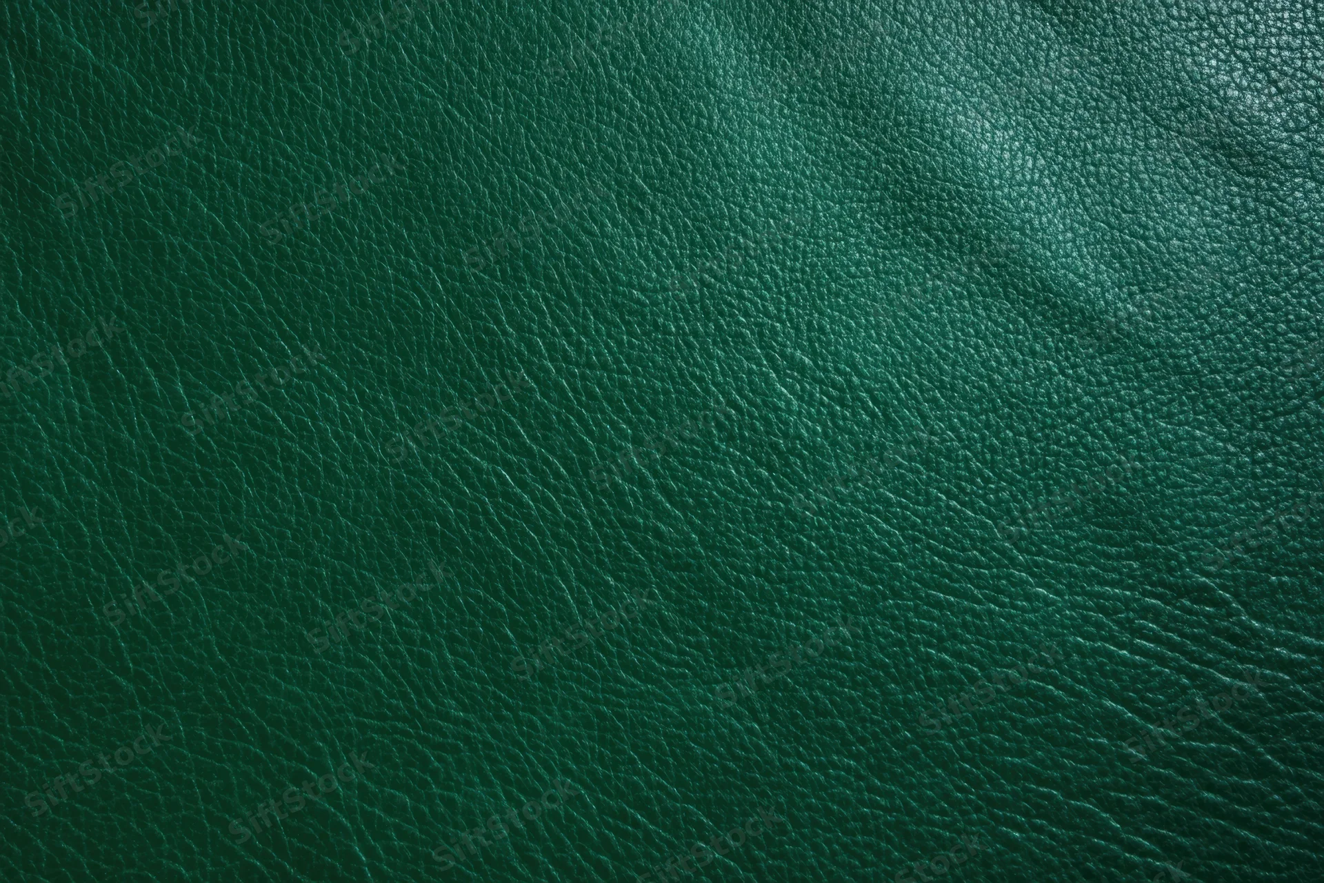 Close-up of dark emerald green leather texture filling the frame