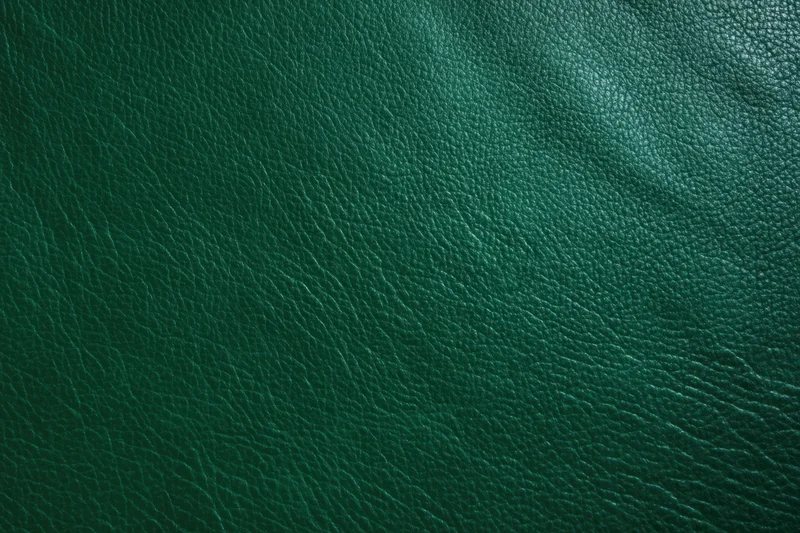 Close-up of dark emerald green leather texture filling the frame
