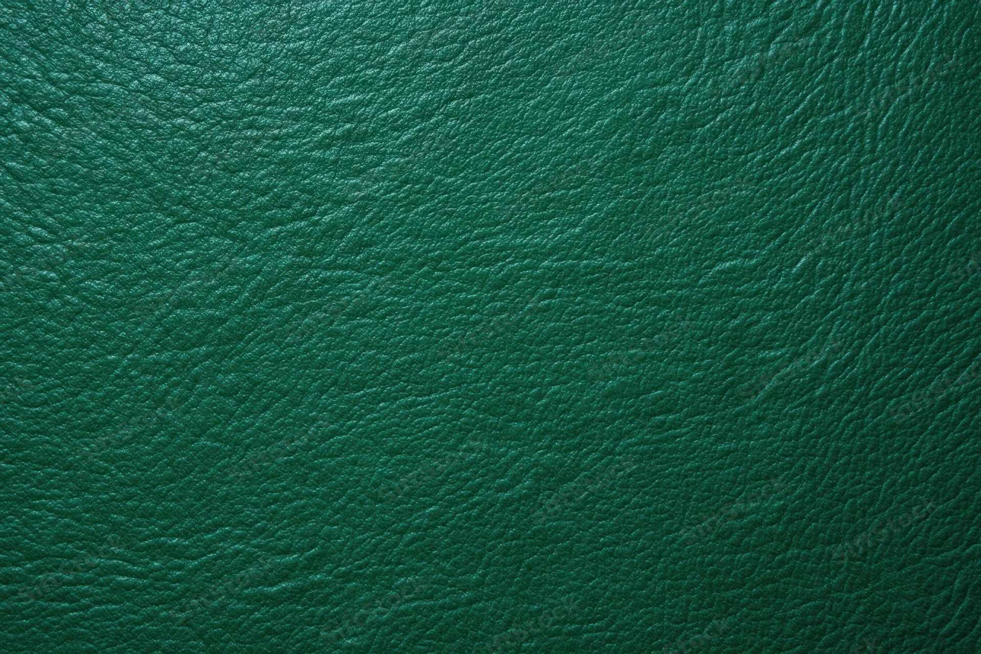 Close-up of dark emerald green textured leather surface