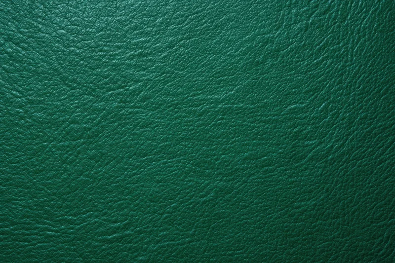 Close-up of dark emerald green textured leather surface