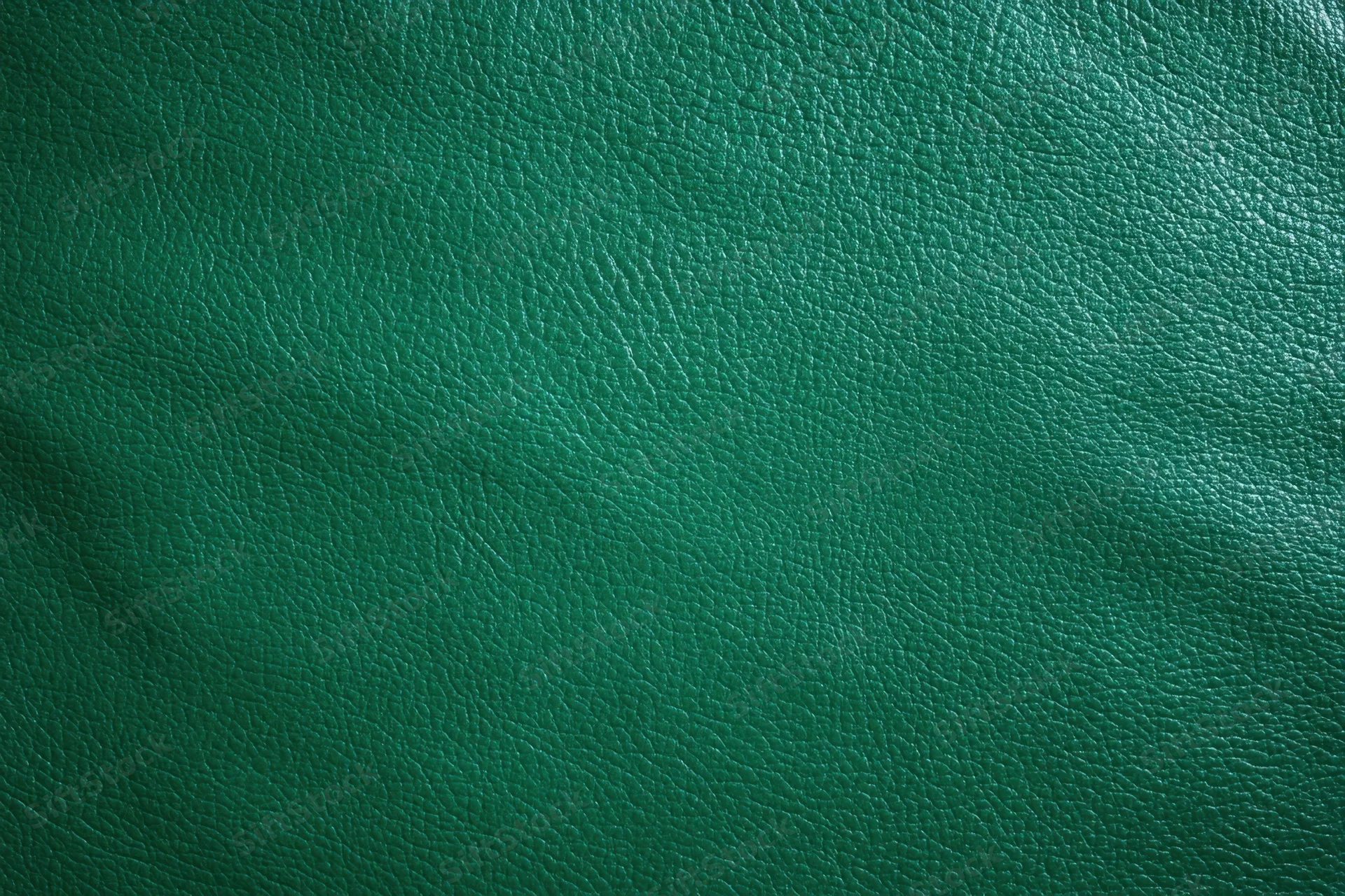 Close-up of dark emerald green textured leather surface