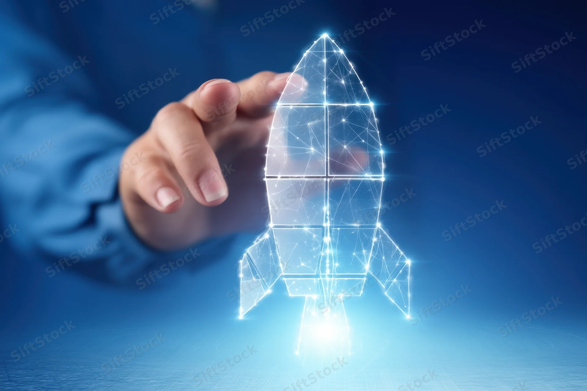 Hand reaching toward a glowing digital rocket hologram on a blue surface