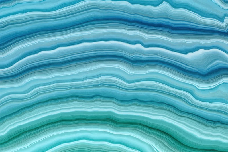 Close-up of blue and teal wavy layered marble pattern
