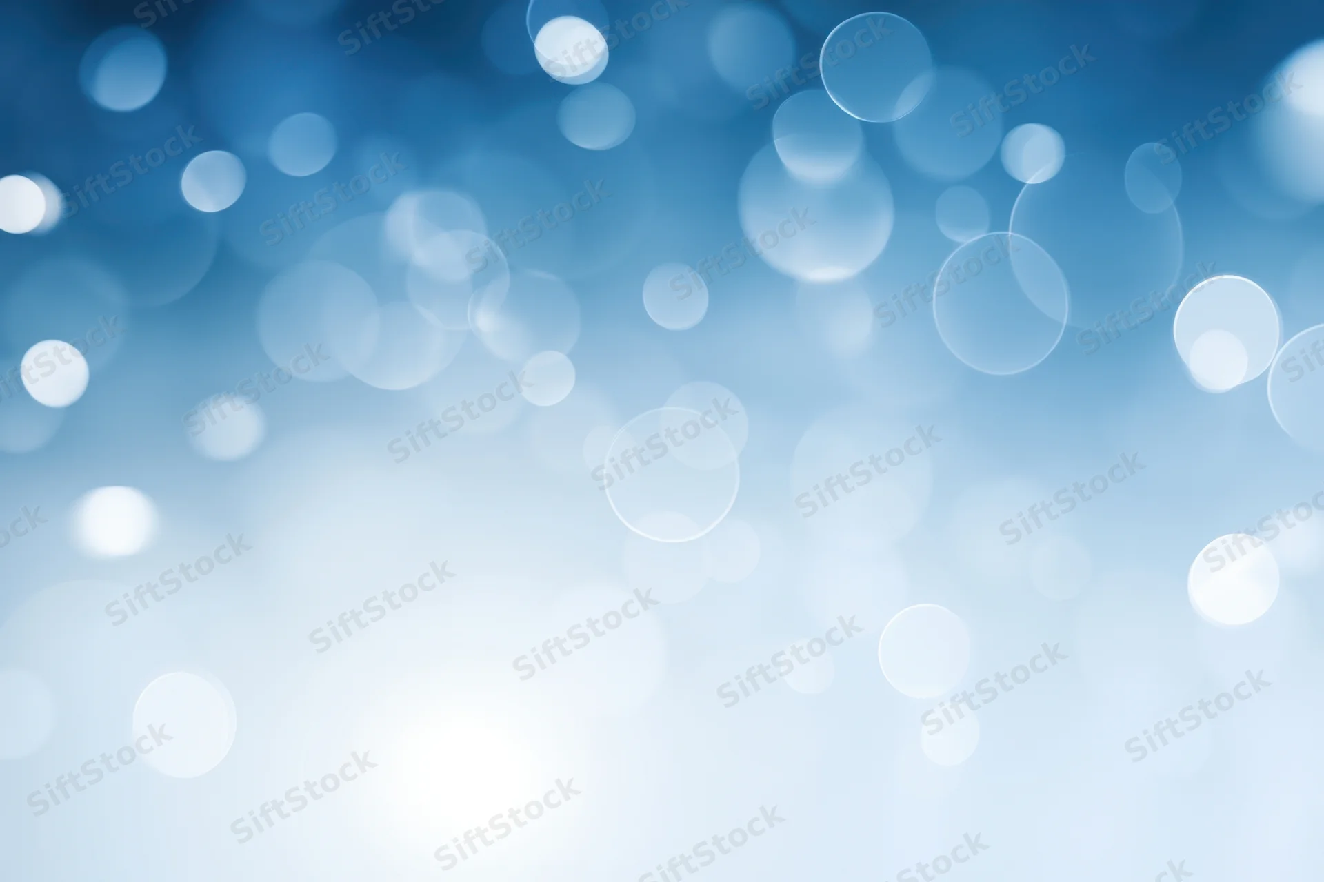 Soft white bokeh circles on a cool blue gradient background