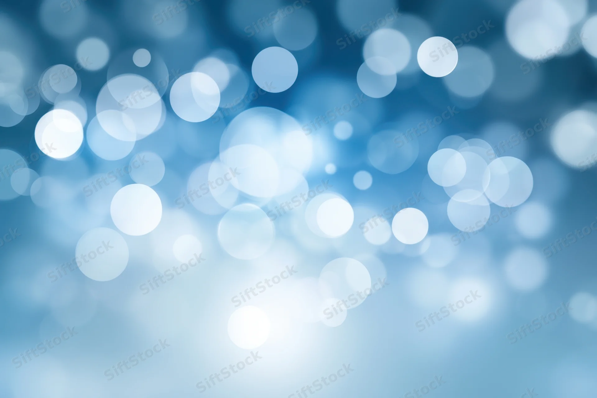 Soft white bokeh lights on a cool blue gradient background