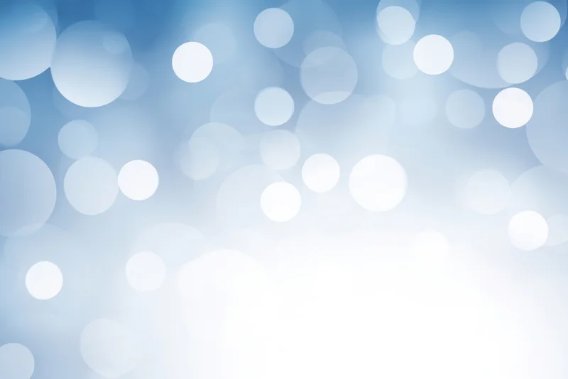 Bokeh background of soft blue glowing circles creating dreamy abstract light