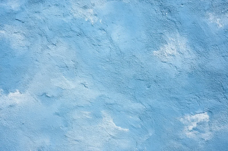 Textured blue plaster wall with white patina and rough surface