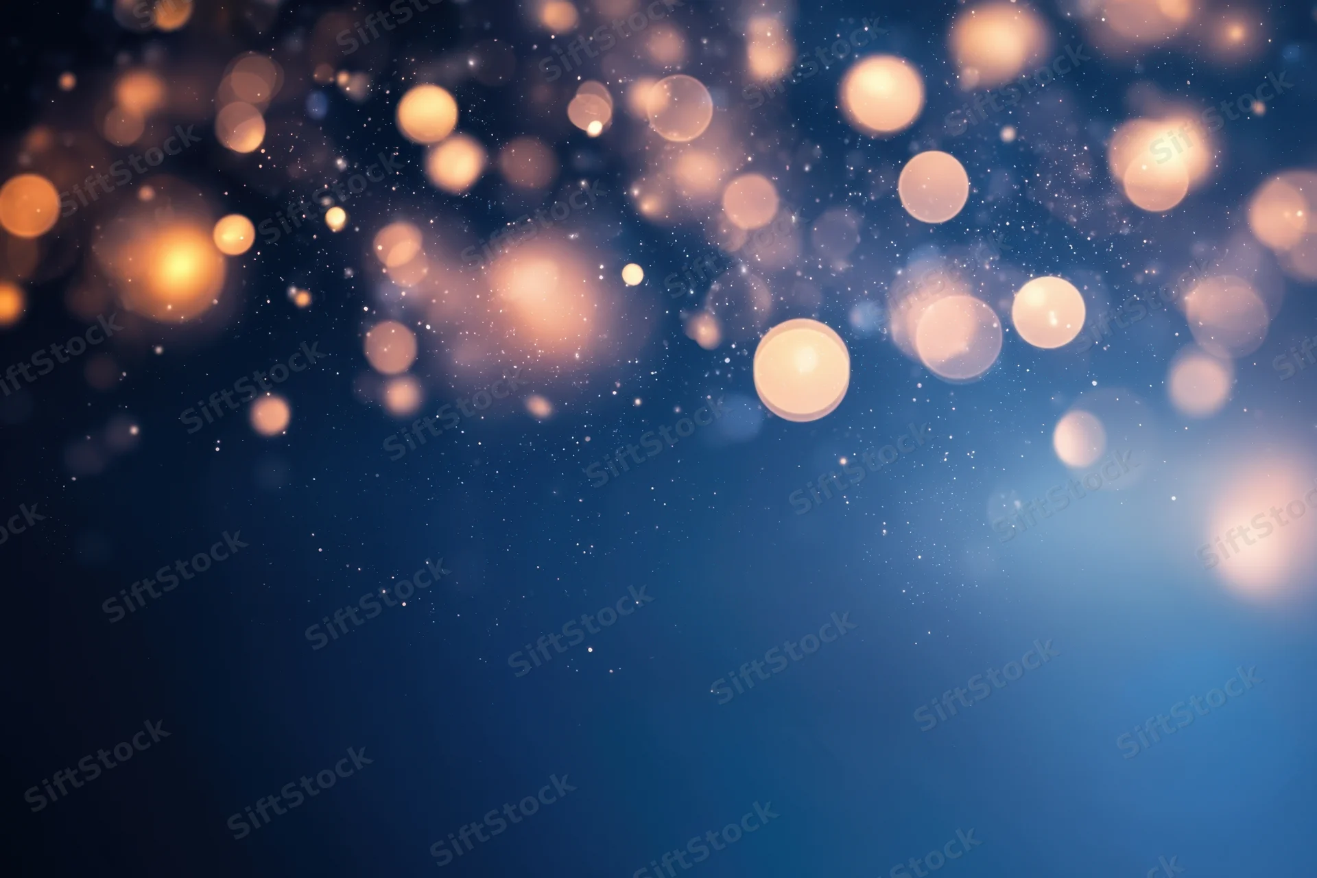 Soft warm bokeh lights on a deep blue gradient background with sparkling particles