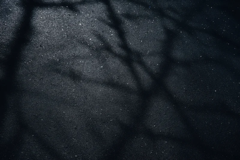 Dark grunge-textured wall with speckled highlights and cracked surface