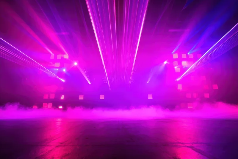 Neon-lit stage with purple and pink laser beams and fog over concrete floor