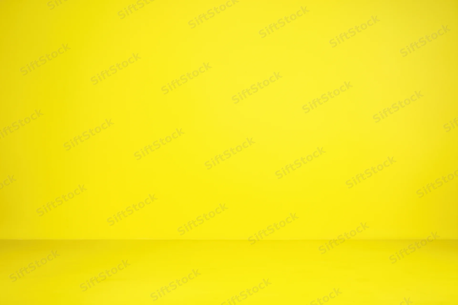 Seamless yellow studio backdrop with smooth wall and floor