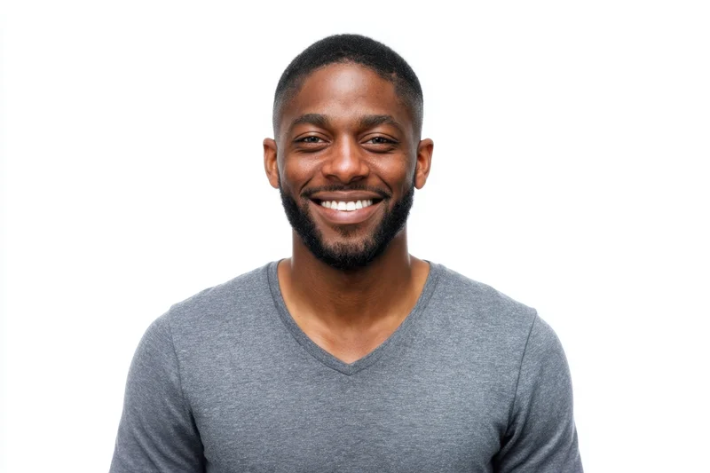 Smiling black man in gray v-neck t-shirt against white background