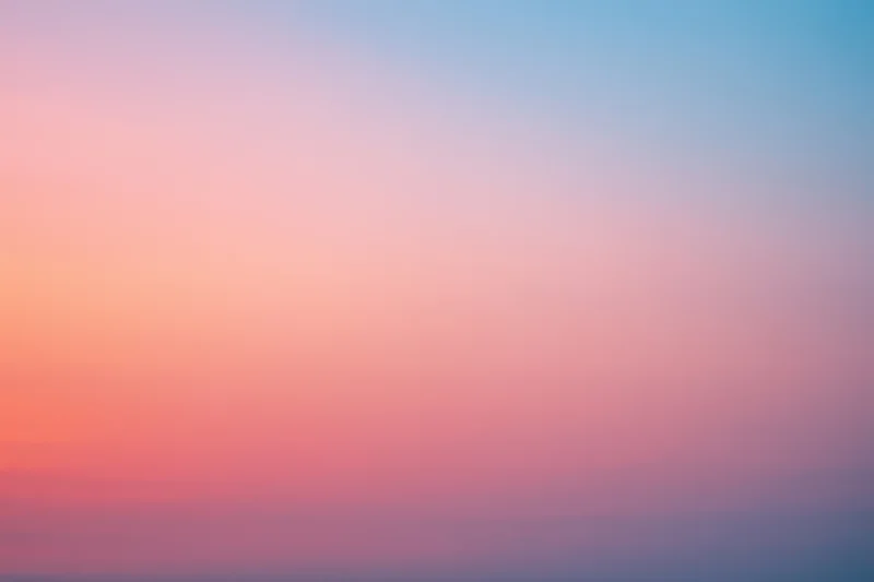 Soft pastel gradient sky blending pink and blue at dusk