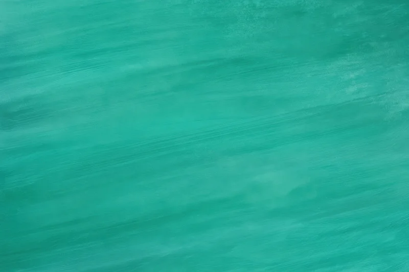 Teal-green painted backdrop with visible brush strokes and soft texture