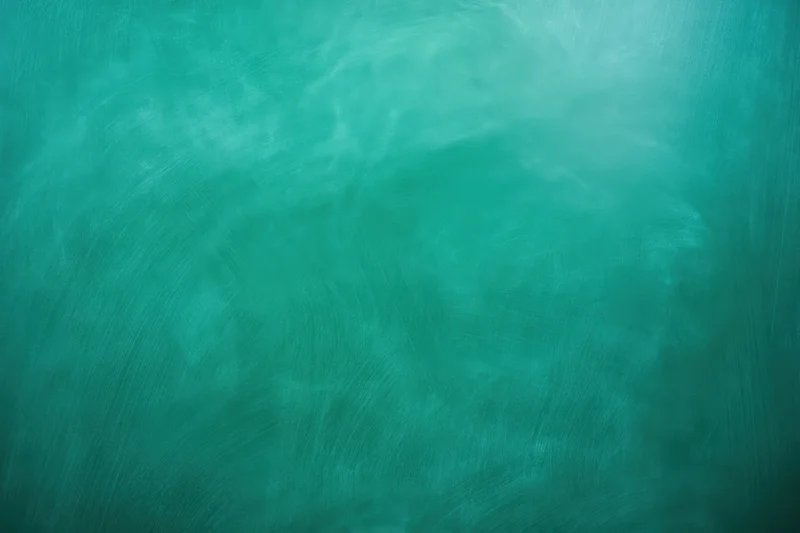 Teal-green painted backdrop with visible brush strokes and textured surface