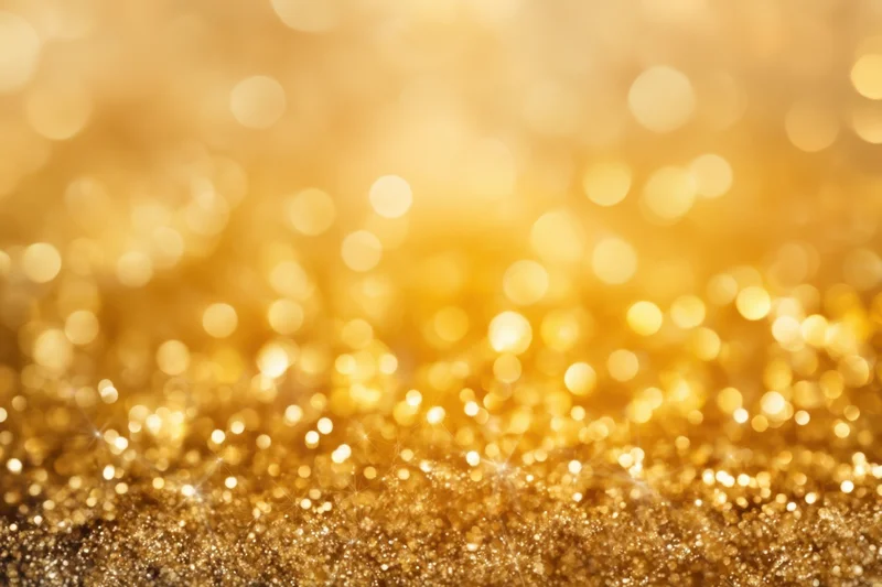 Golden glitter with shimmering bokeh lights across the frame