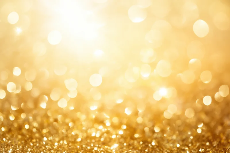 Warm golden bokeh scene with shimmering light orbs sparkle