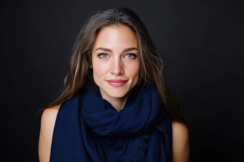 Woman smiling with blue scarf in studio portrait