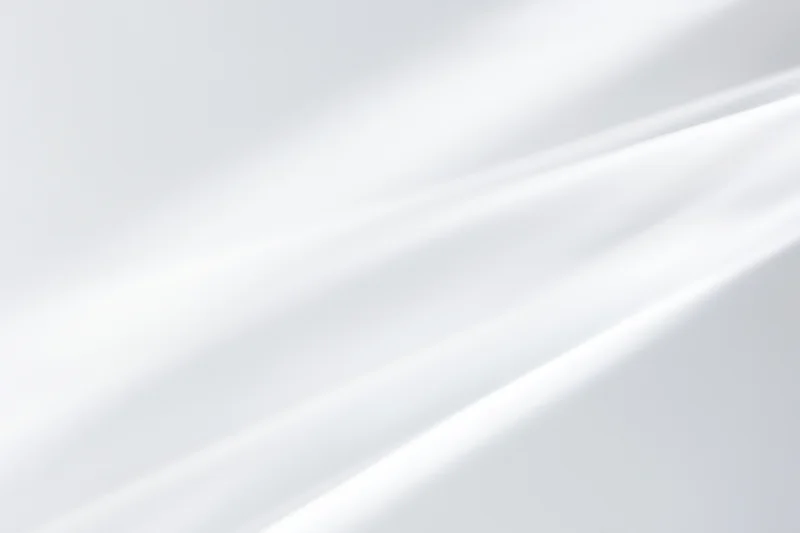Soft diagonal light streaks on a bright white minimal background