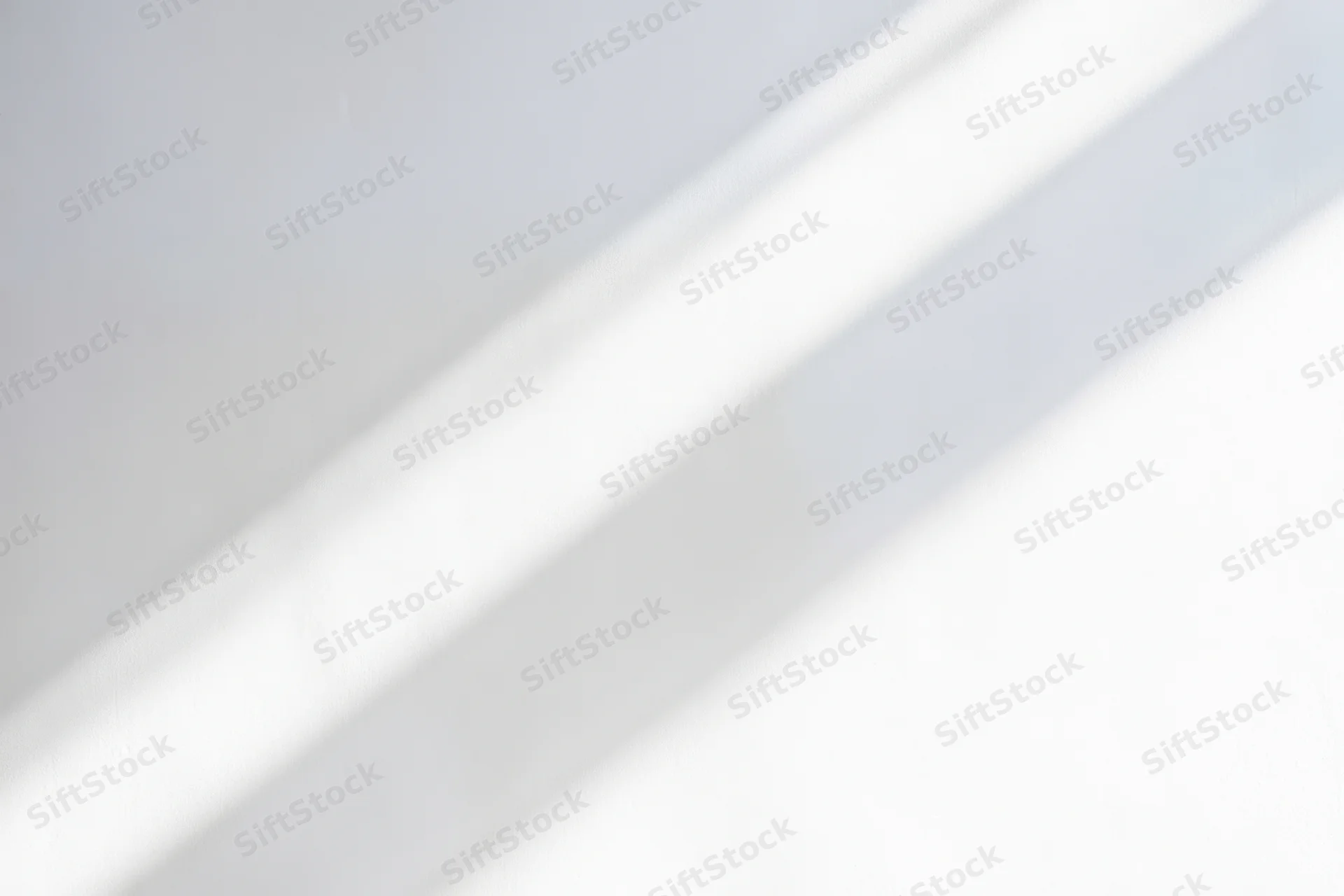 Diagonal light streaks on a bright white minimal background