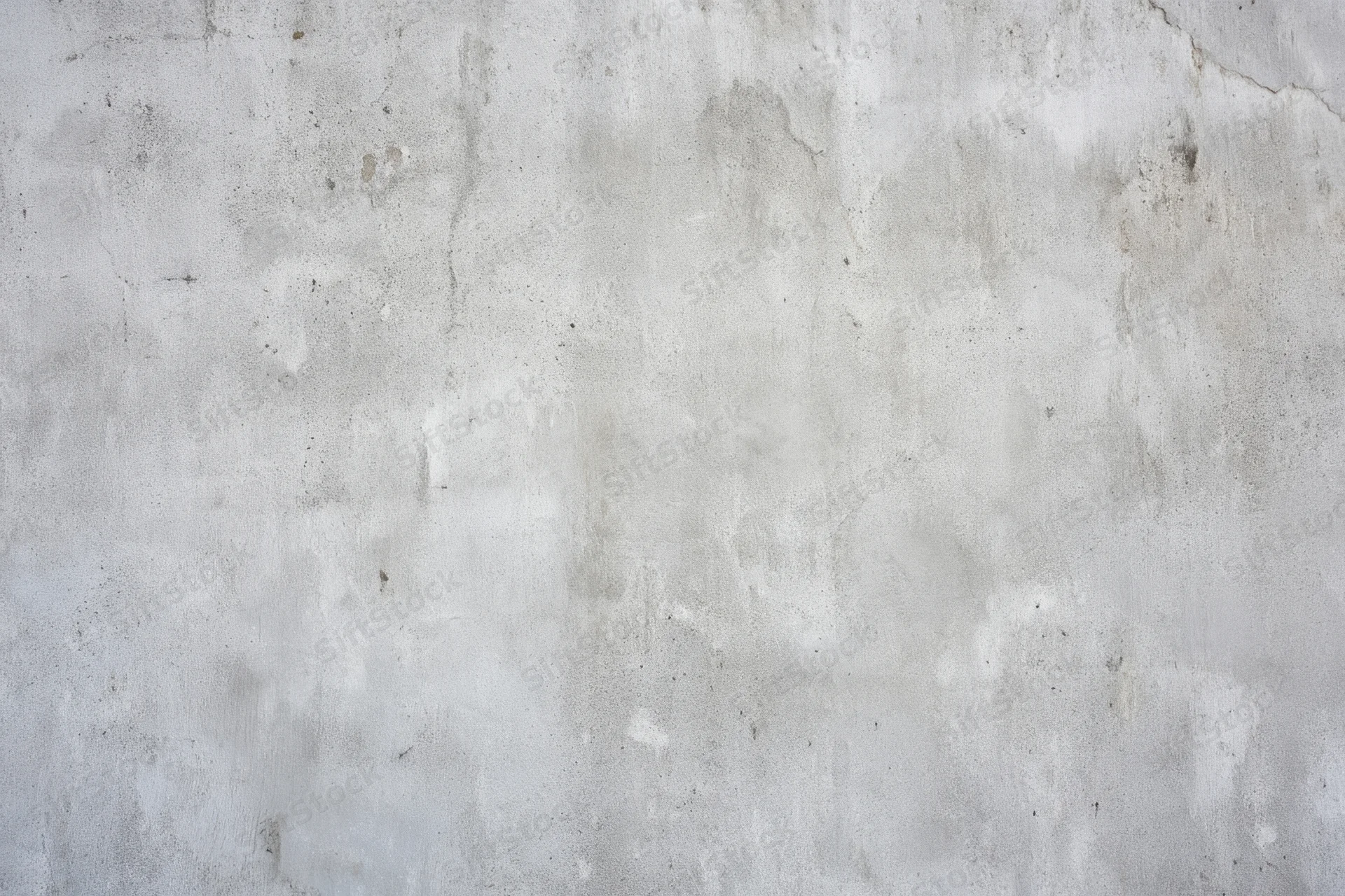 Close-up of a weathered light gray concrete wall surface
