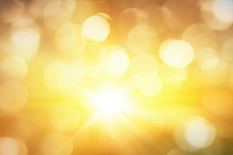 Golden bokeh lights glowing softly in a warm abstract background