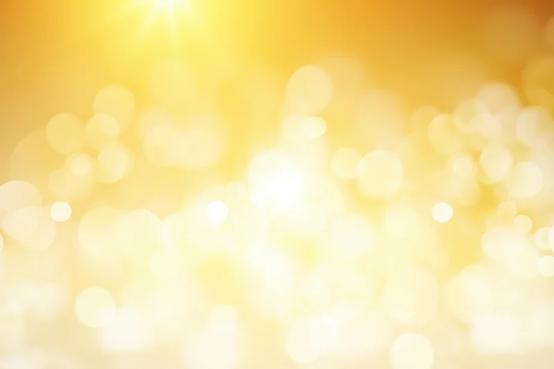 Warm golden gradient with soft bokeh highlights and glowing light effects