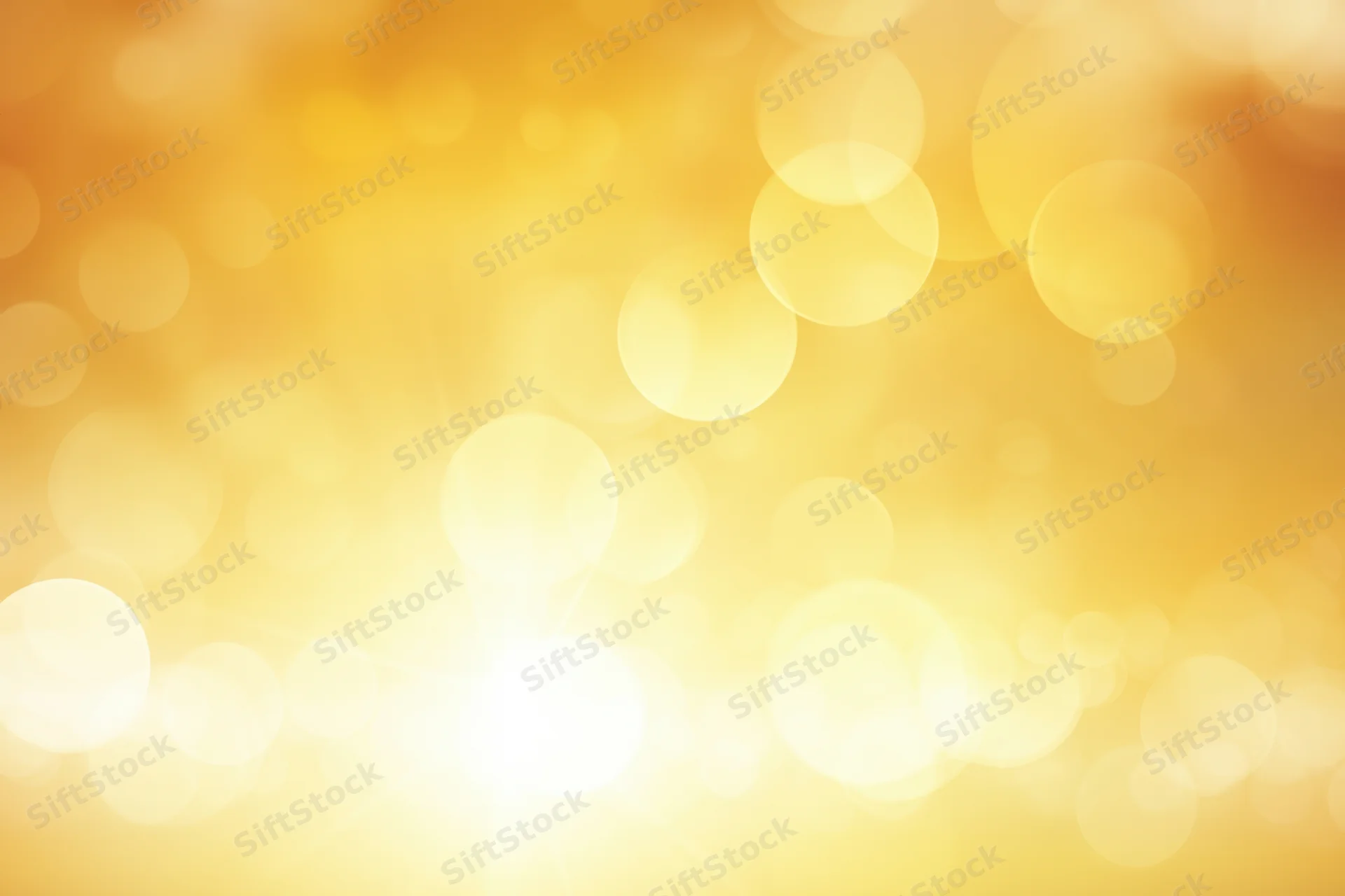 Warm golden gradient with soft bokeh highlights and bright glow