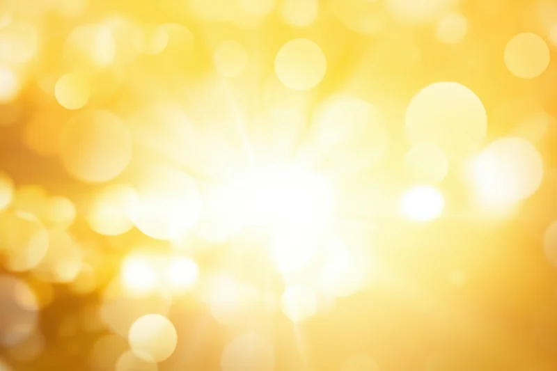 Warm golden gradient with bright highlights and soft bokeh