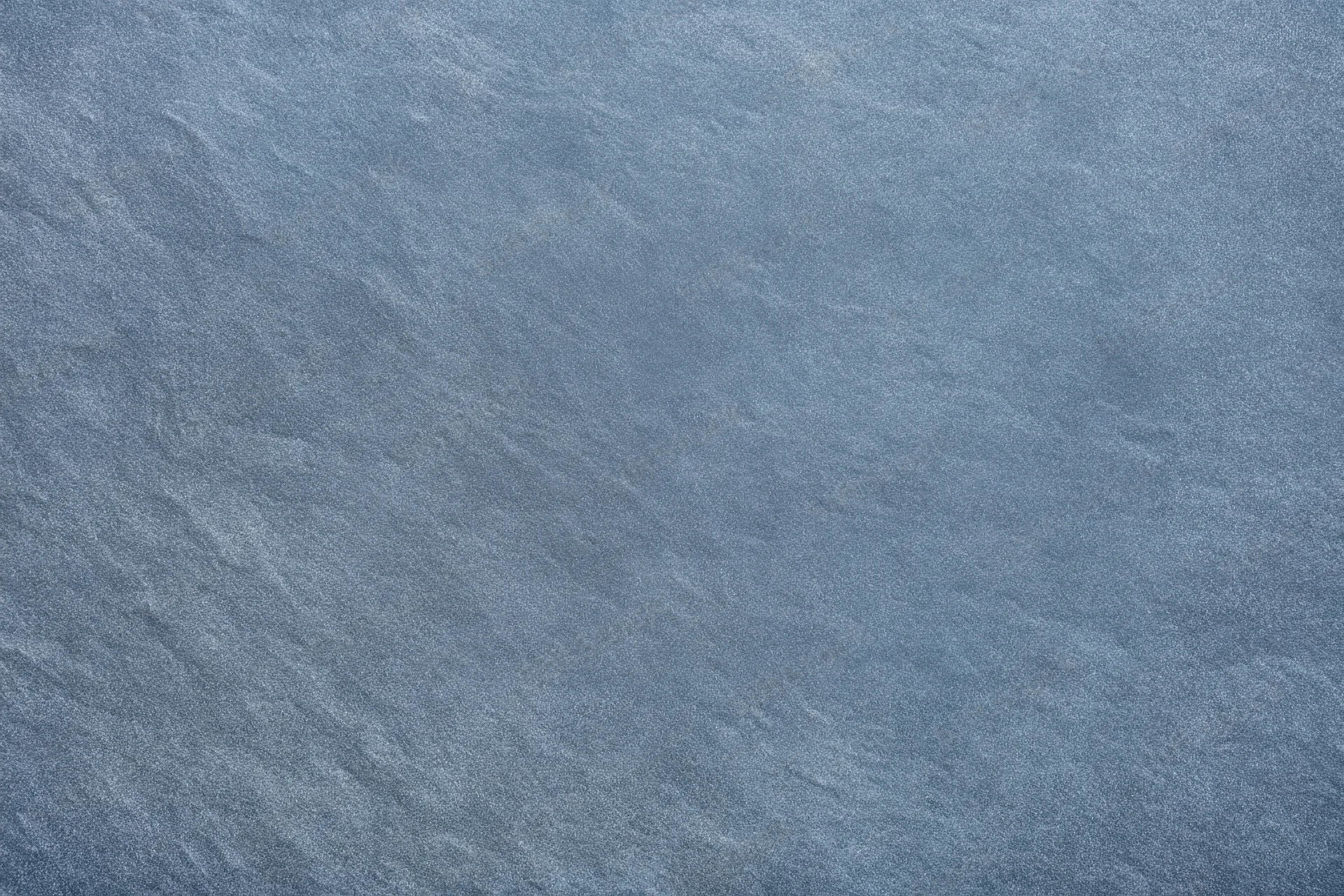 Close-up of blue-gray textured fabric surface with fine weave pattern