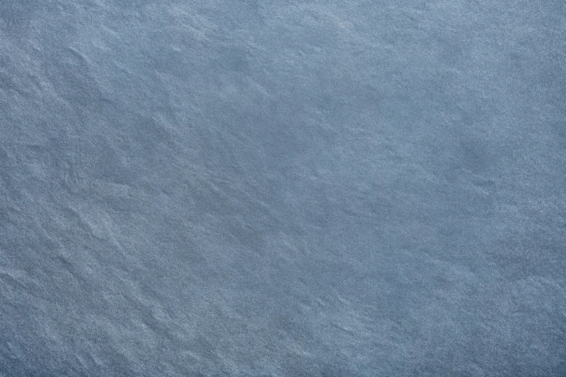 Close-up of blue-gray textured fabric surface with fine weave pattern