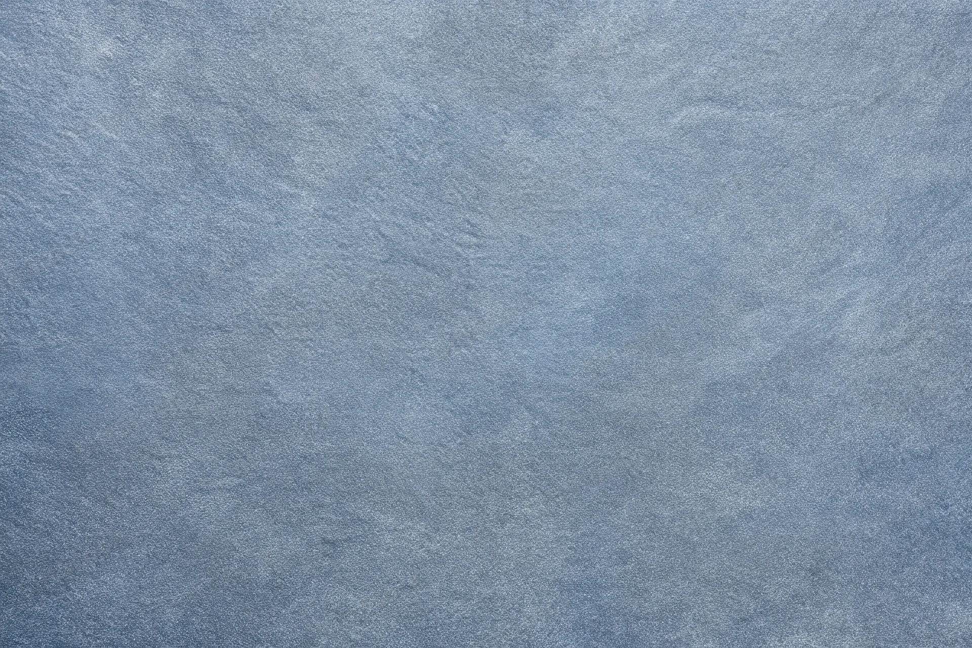 Close-up of blue-gray textured fabric surface with fine grain pattern