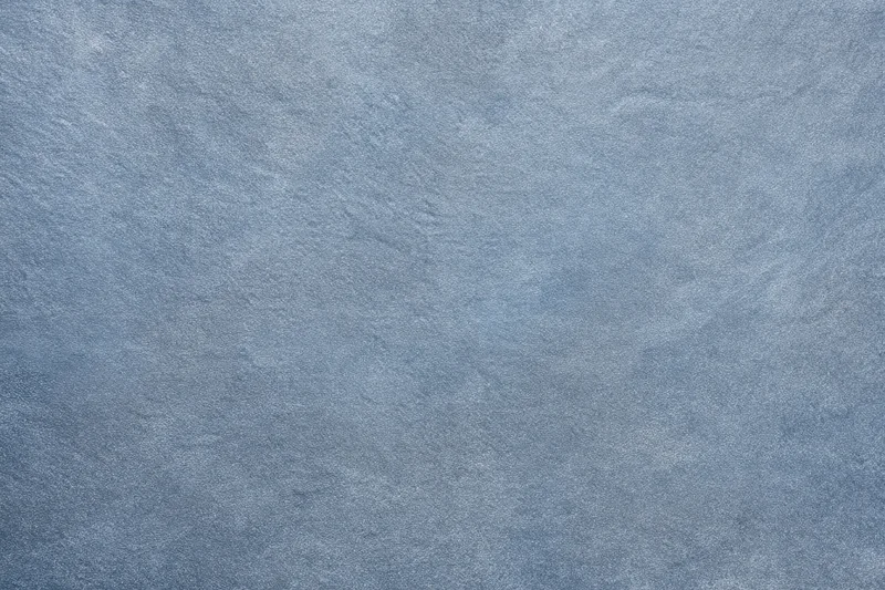 Close-up of blue-gray textured fabric surface with fine grain pattern