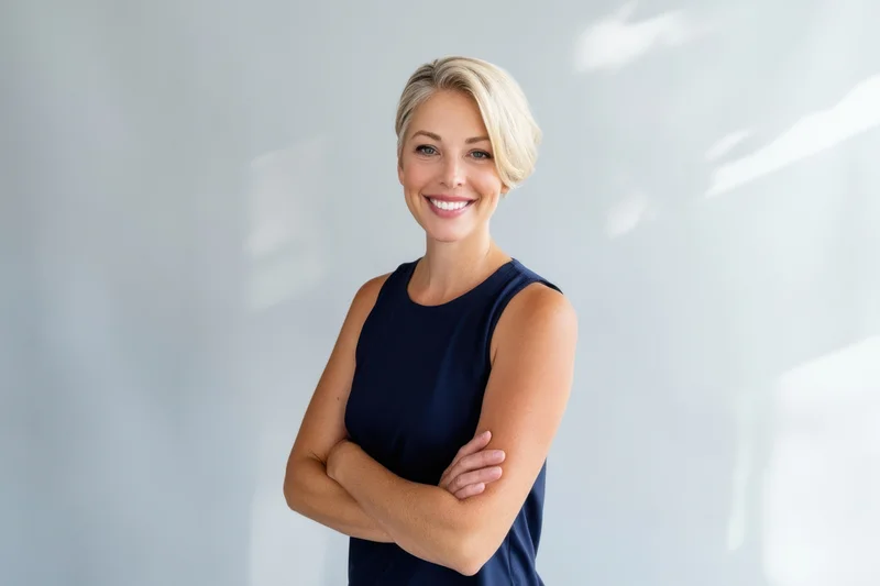 Confident woman with arms crossed smiling in a modern office interior